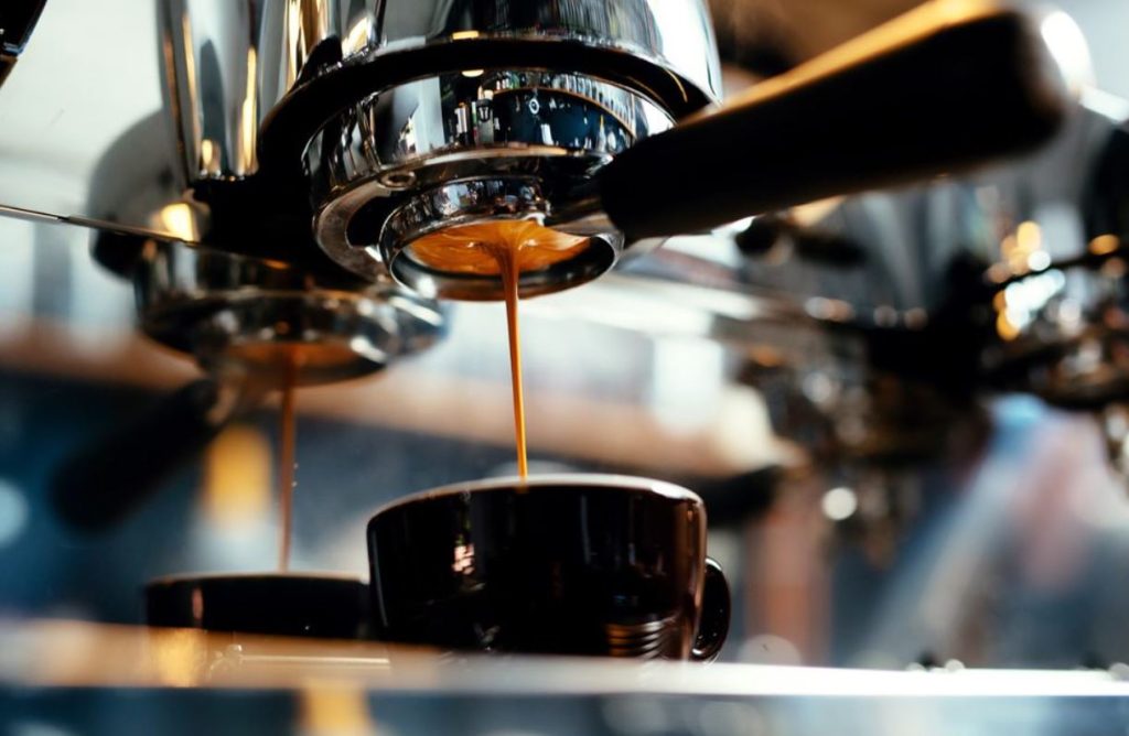 Upclose of coffee being brewed and dripping into a cup.