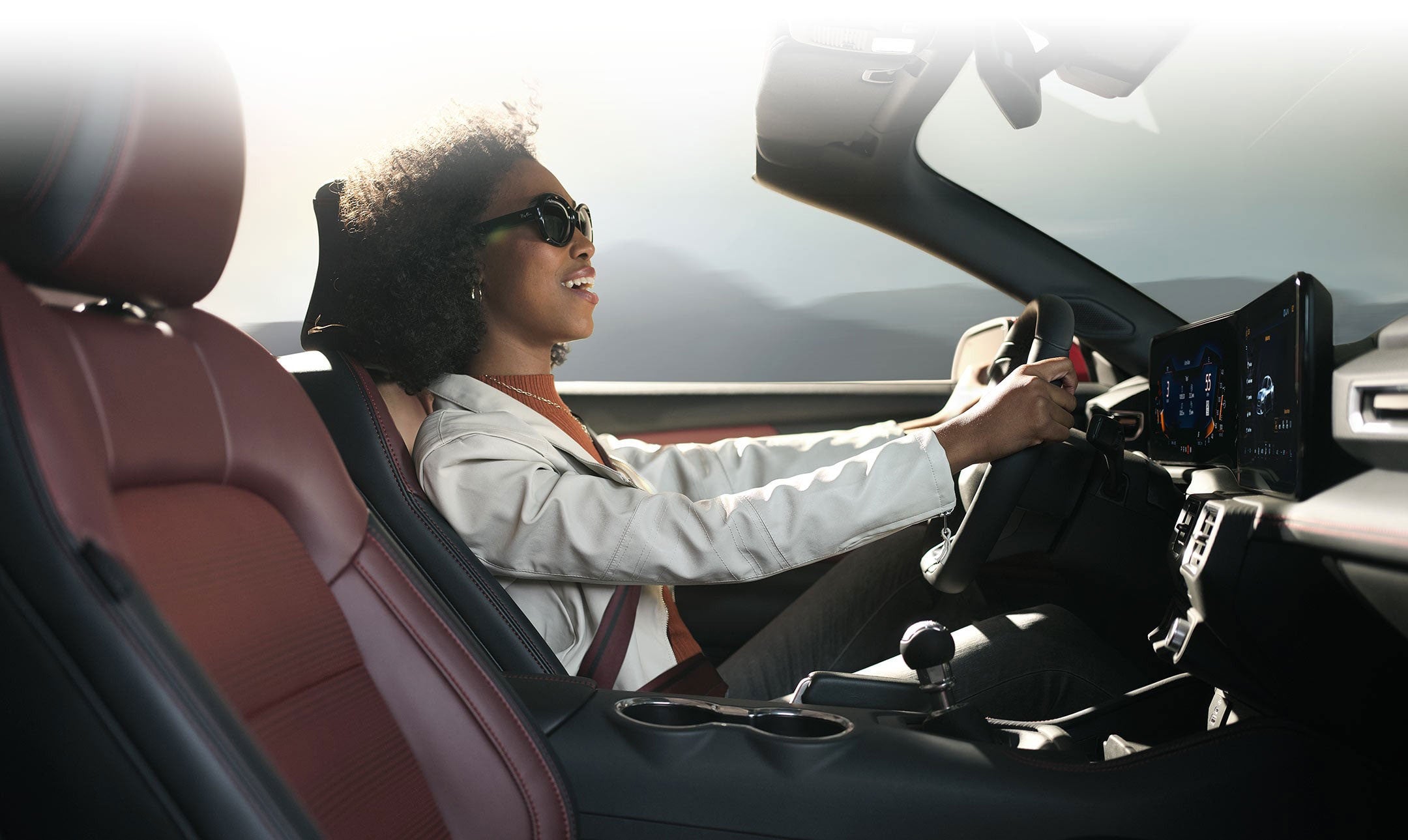 Person sitting in the driver’s seat of a 2024 Ford Mustang® convertible | Coughlin Ford of Heath in Newark OH